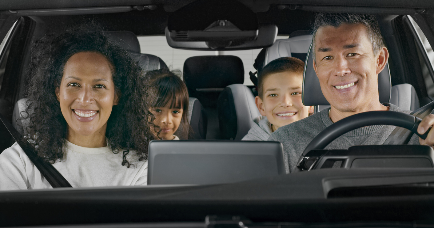 Family sitting in modern car